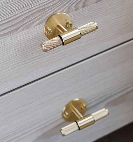 close up of gold tbar handles