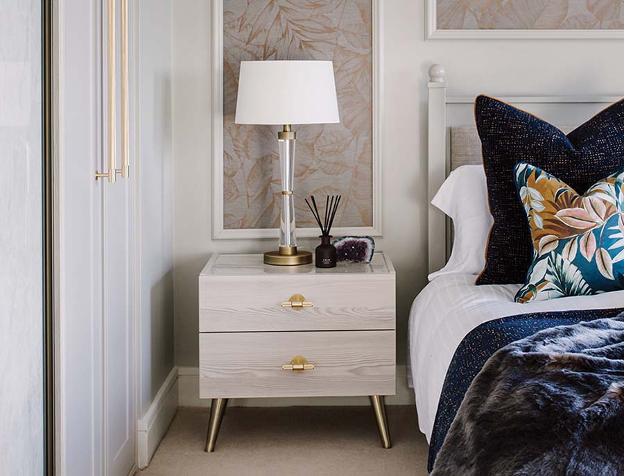 freestanding woodgrain chest of drawers with gold tbar handles