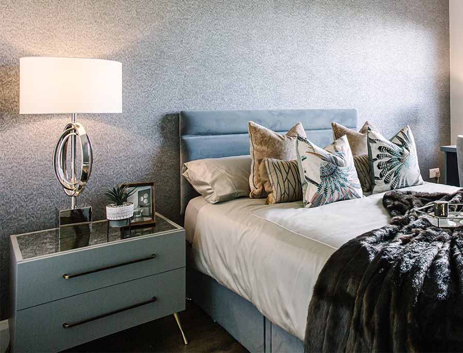 freestanding chest of drawers beside a bed