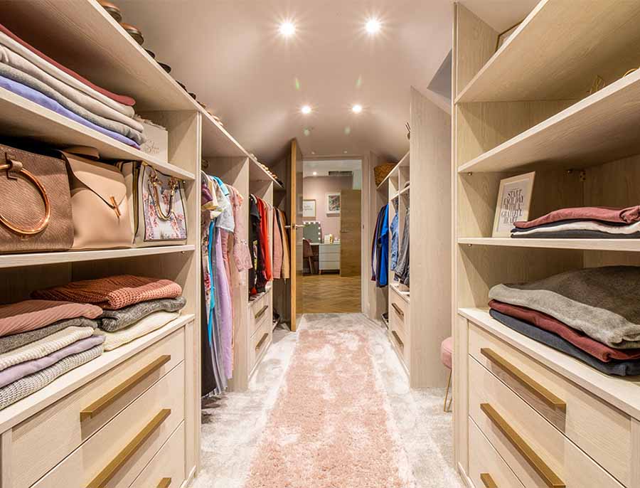 walk in wardrobe with clothes and handbags