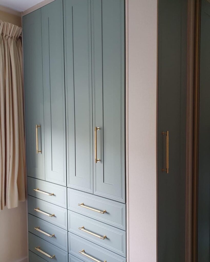 close up of blue hinge wardrobe with gold handles