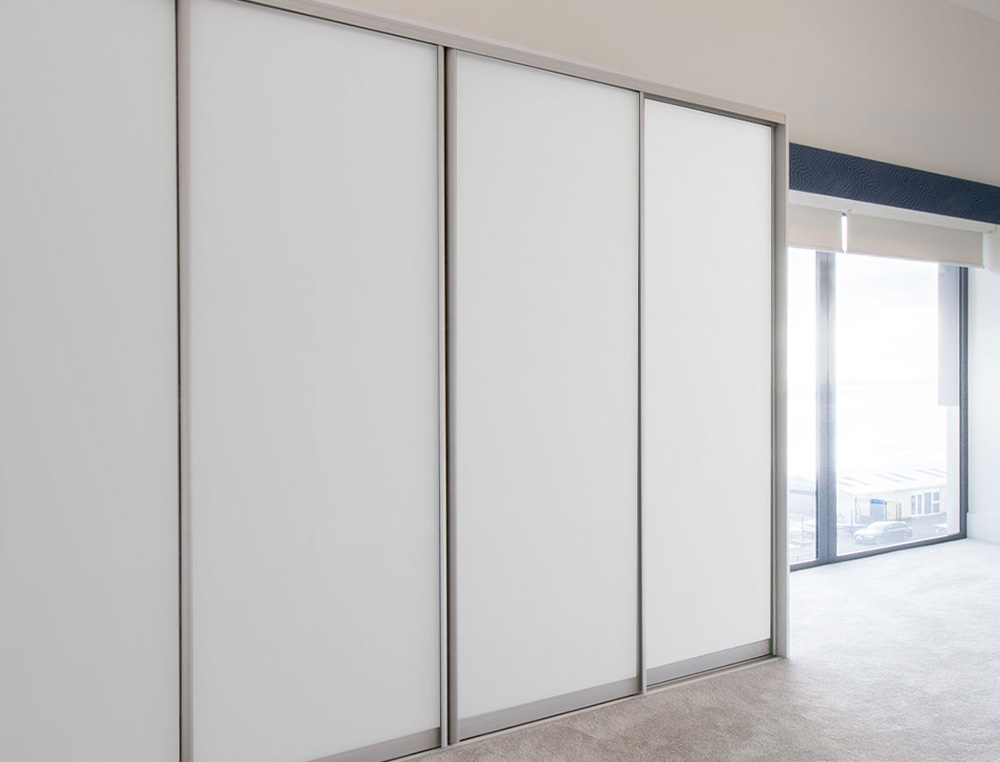 close up of white glass sliding wardrobe