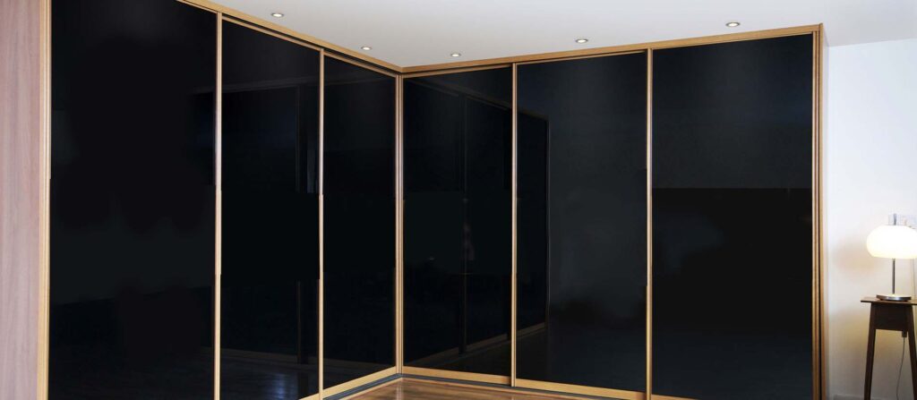 black glass with gold frame sliding wardrobe